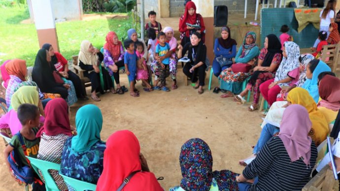 IDP women sit in a circle to discuss during Participatory Action Learning in the Philippines