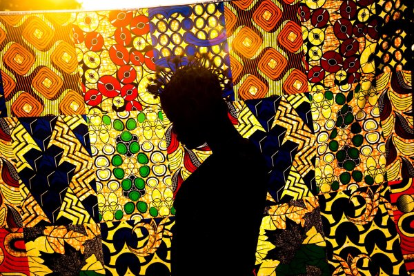 Silhouette of a young woman against a colorful background